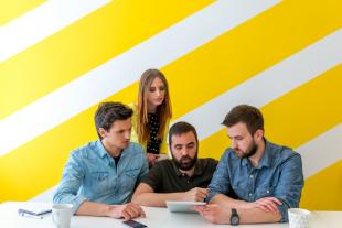 Employees looking at online learning course from a tablet